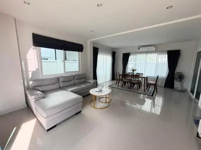 a living room with a couch and a table at Cozy House by Cody One in Thalang