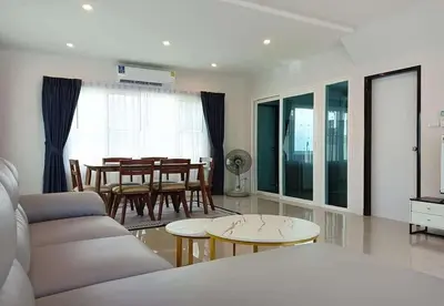 a living room with a couch and a table at Cozy House by Cody One in Thalang