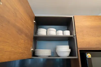 a cupboard with plates and dishes in it at House 158 Patong Pool Villa 4BR Near Beach in Patong Beach