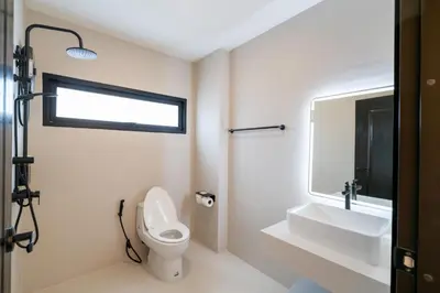 a bathroom with a toilet and a sink and a mirror at House 158 Patong Pool Villa 4BR Near Beach in Patong Beach