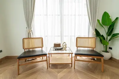 two chairs and a coffee table in front of a window at House 158 Patong Pool Villa 4BR Near Beach in Patong Beach