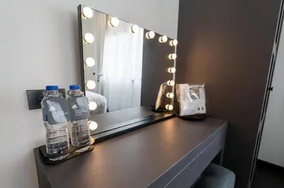 a vanity with two bottles of water and a mirror at House 158 Patong Pool Villa 4BR Near Beach in Patong Beach