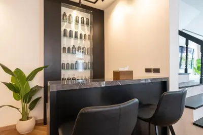 a bar in a room with two chairs at House 158 Patong Pool Villa 4BR Near Beach in Patong Beach