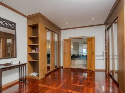a living room with wooden shelves and a wooden floor at Golden Horizon Villa 02 in Ban Ao Kung