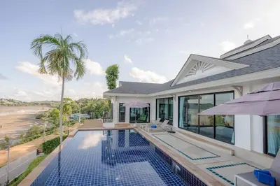 a villa with a swimming pool and a house at Golden Horizon Villa 02 in Ban Ao Kung