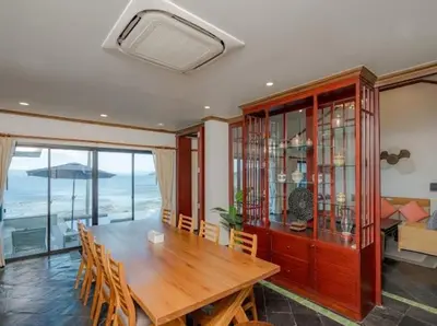 a dining room with a large wooden table and chairs at Golden Horizon Villa 02 in Ban Ao Kung