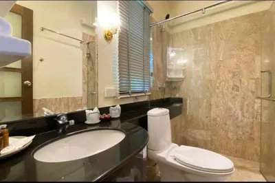 a bathroom with a sink and a toilet and a mirror at Golden Horizon Villa 02 in Ban Ao Kung