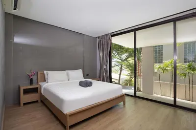 a bedroom with a white bed and a large window at Sea View & Tropical Bliss - 2BR Villa Natural Touch A4 at Kamala Hill in Kamala Beach