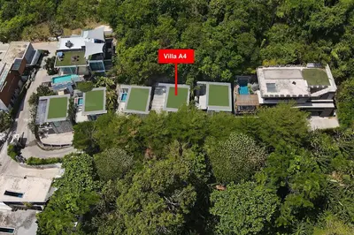a red sign on top of a house with trees at Sea View & Tropical Bliss - 2BR Villa Natural Touch A4 at Kamala Hill in Kamala Beach