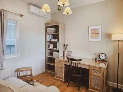 a living room with a desk and a chair at Little Cottage - 3BR House for family vacation By Little Latte House in Ban Pa Khlok