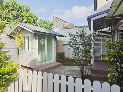 a white fence in front of a house at Little Cottage - 3BR House for family vacation By Little Latte House in Ban Pa Khlok