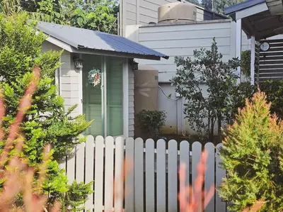 a white fence in front of a house at Little Cottage - 3BR House for family vacation By Little Latte House in Ban Pa Khlok