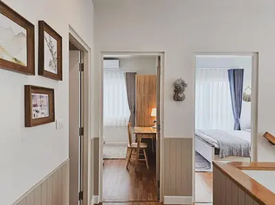 a bedroom with a bed and a desk and a table at Little Cottage - 3BR House for family vacation By Little Latte House in Ban Pa Khlok