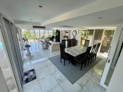 a dining room and living room with a table and chairs at 30 - Panoramic View Villa in Thalang in Thalang