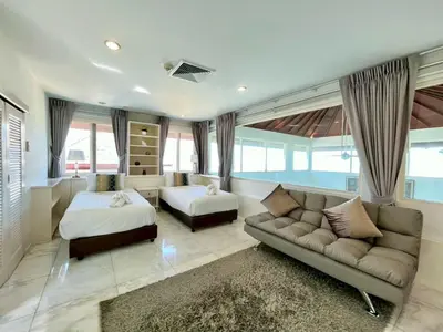a living room with a couch and a bed and a bed and a bed at 30 - Panoramic View Villa in Thalang in Thalang