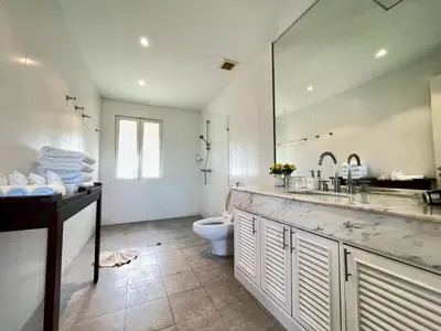 a bathroom with a toilet and a sink and a mirror at 30 - Panoramic View Villa in Thalang in Thalang
