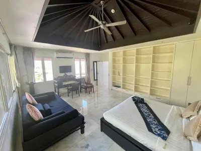 a living room with a couch and a ceiling fan at 30 - Panoramic View Villa in Thalang in Thalang
