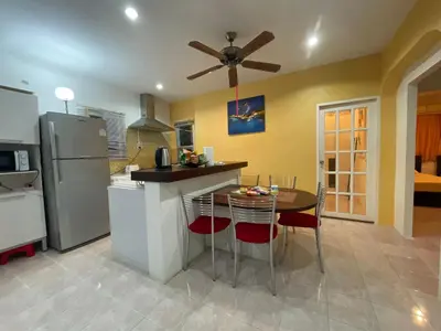 a kitchen with a table and a refrigerator at 3 bedrooms Semi-Detached with Pool near Kamala Beach in Kamala Beach