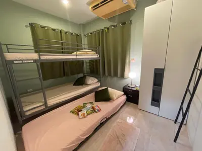 two bunk beds in a room with a tv at 3 bedrooms Semi-Detached with Pool near Kamala Beach in Kamala Beach
