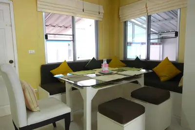 a dining room with a table and two chairs at 2 bedroom Semi-Detached Holiday Home with Pool near Kamala Beach in Kamala Beach