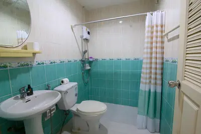 a bathroom with a toilet and a sink and a mirror at 2 bedroom Semi-Detached Holiday Home with Pool near Kamala Beach in Kamala Beach