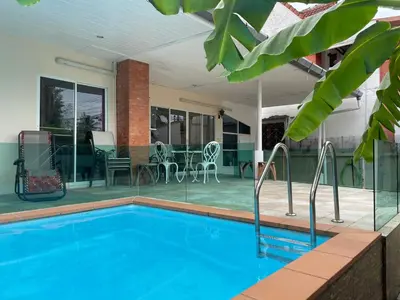 a swimming pool in front of a house at 2 bedroom Semi-Detached Holiday Home with Pool near Kamala Beach in Kamala Beach