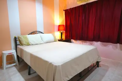 a bed in a room with a red curtain at 2 bedroom Semi-Detached Holiday Home with Pool near Kamala Beach in Kamala Beach