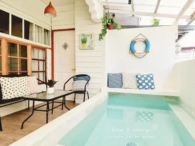 a swimming pool in the middle of a house at Little Latte House - Chalong in Ban Na Bon