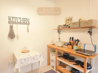 a kitchen with a wooden shelf and a table at Little Latte House - Chalong in Ban Na Bon