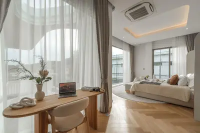 a bedroom with a bed and a desk with a table at Nature's Rest Private Pool Villa Rawai in Phuket Town