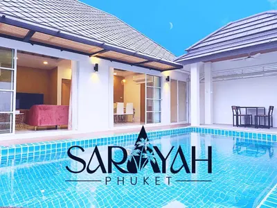 a swimming pool in front of a house at Sarayah Phuket Pool Villa in Phuket Town