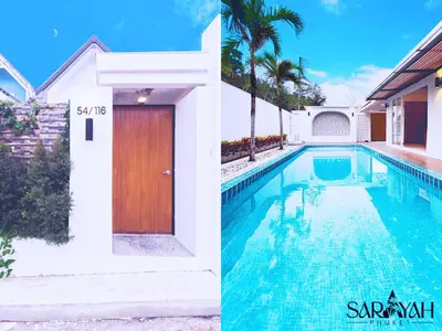 a house with a swimming pool and a wooden door at Sarayah Phuket Pool Villa in Phuket Town