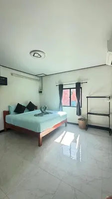a bedroom with a bed and a large window at Relax sunsmile Kohyaonoi in Ko Yao Noi