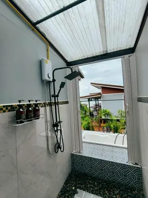 a shower in a bathroom with a window at Relax sunsmile Kohyaonoi in Ko Yao Noi