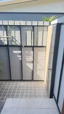 a garage with two doors on the side of a house at Relax sunsmile Kohyaonoi in Ko Yao Noi