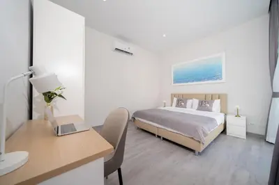 a bedroom with a bed and a desk with a laptop at Brand New Villa in Ravai for a wonderful holiday 3 - bedroom in Ban Saiyuan (1)