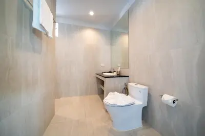 a bathroom with a white toilet and a sink at Brand New Villa in Ravai for a wonderful holiday 3 - bedroom in Ban Saiyuan (1)