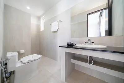 a bathroom with a sink and a toilet and a mirror at Brand New Villa in Ravai for a wonderful holiday 3 - bedroom in Ban Saiyuan (1)