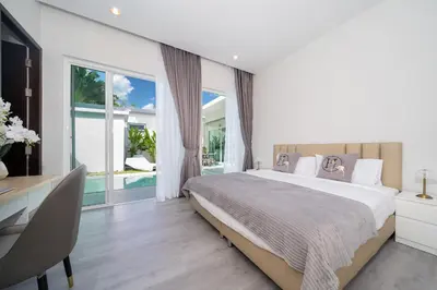 a bedroom with a large bed and a desk and window at Brand New Villa in Ravai for a wonderful holiday 3 - bedroom in Ban Saiyuan (1)