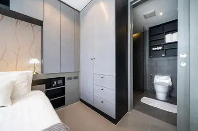 a bedroom with a bed and a toilet in it at CityGate Kamala in Kamala Beach