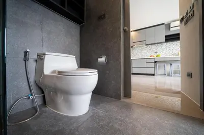 a bathroom with a white toilet in a room at CityGate Kamala in Kamala Beach