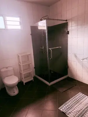 a bathroom with a shower and a toilet at The Rai Resort Rawai - Pool & Garden in Ban Bang Chak