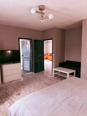 an empty bedroom with a bed and a couch at The Rai Resort Rawai - Pool & Garden in Ban Bang Chak
