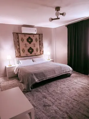 a bedroom with a large bed with a green curtain at The Rai Resort Rawai - Pool & Garden in Ban Bang Chak