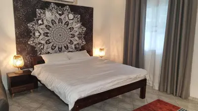 a bedroom with a bed with a black and white wall at The Rai Resort Rawai - Pool & Garden in Ban Bang Chak