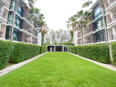 a large lawn in front of a building at Pond View apartment Title Rawai by Clavis in Rawai Beach