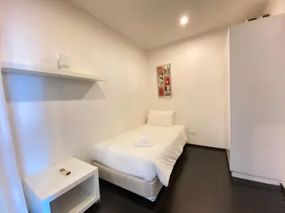 a small white room with a bed and a table at Pond View apartment Title Rawai by Clavis in Rawai Beach