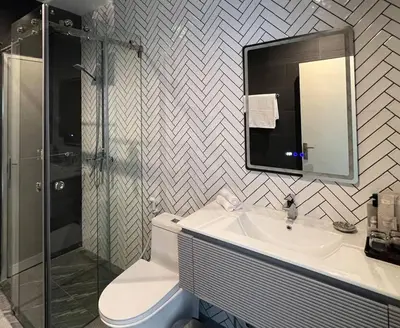 a bathroom with a toilet and a sink and a shower at Seaview 2 BR Spacious Modern Duplex near Kamala beach in Kamala Beach