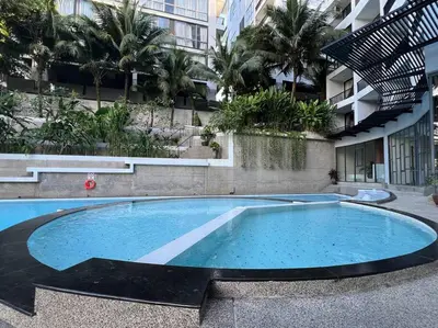 a large swimming pool in front of a building at Seaview 2 BR Spacious Modern Duplex near Kamala beach in Kamala Beach
