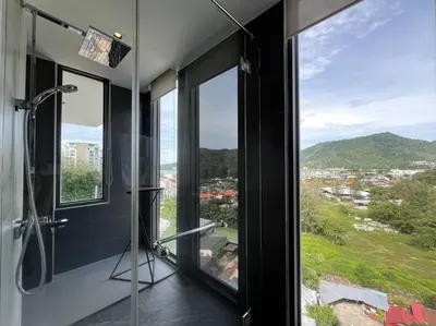 a bathroom with a shower and a large window at Seaview 2 BR Spacious Modern Duplex near Kamala beach in Kamala Beach